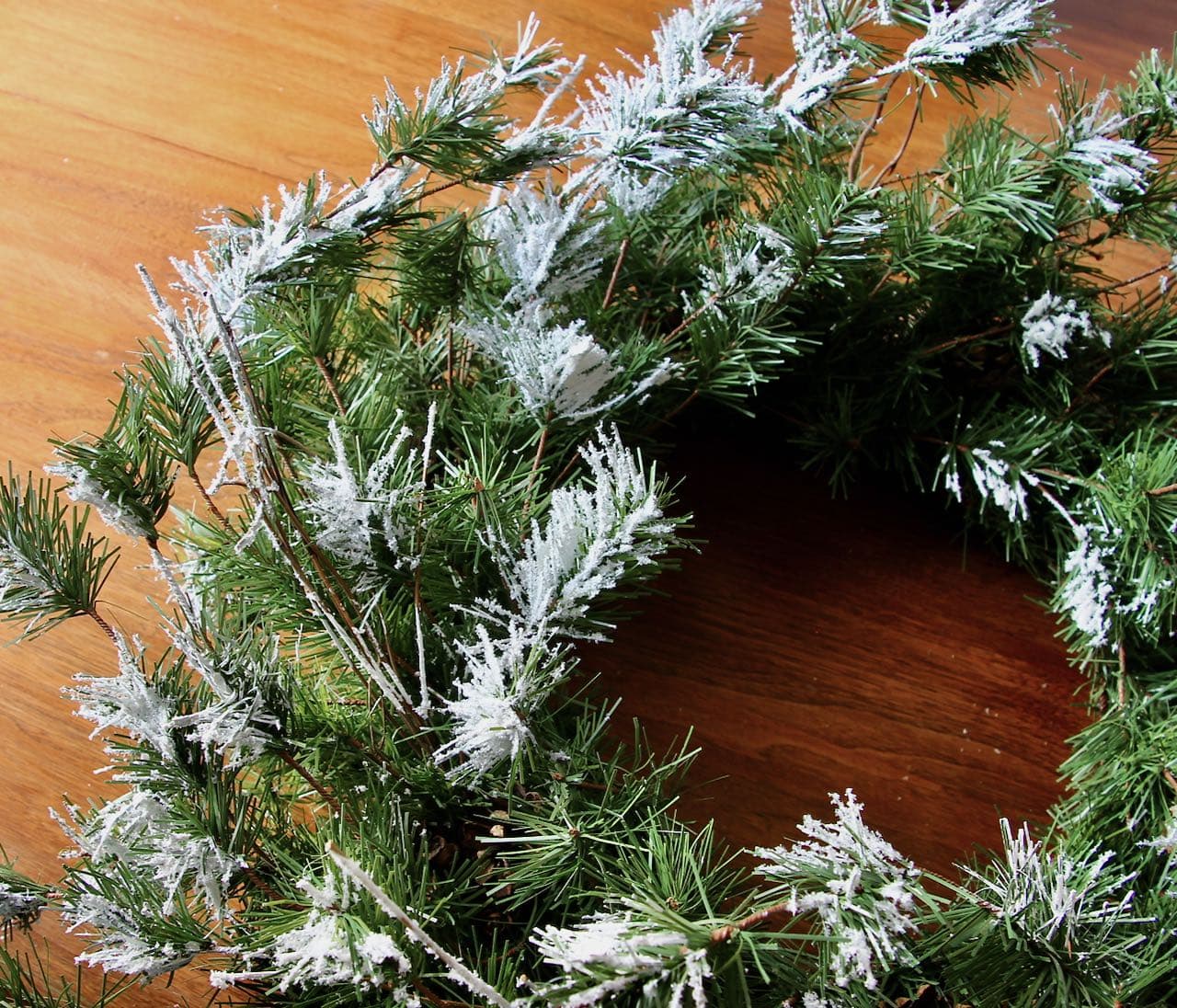 view of partial wreath that has been revived with fake snow