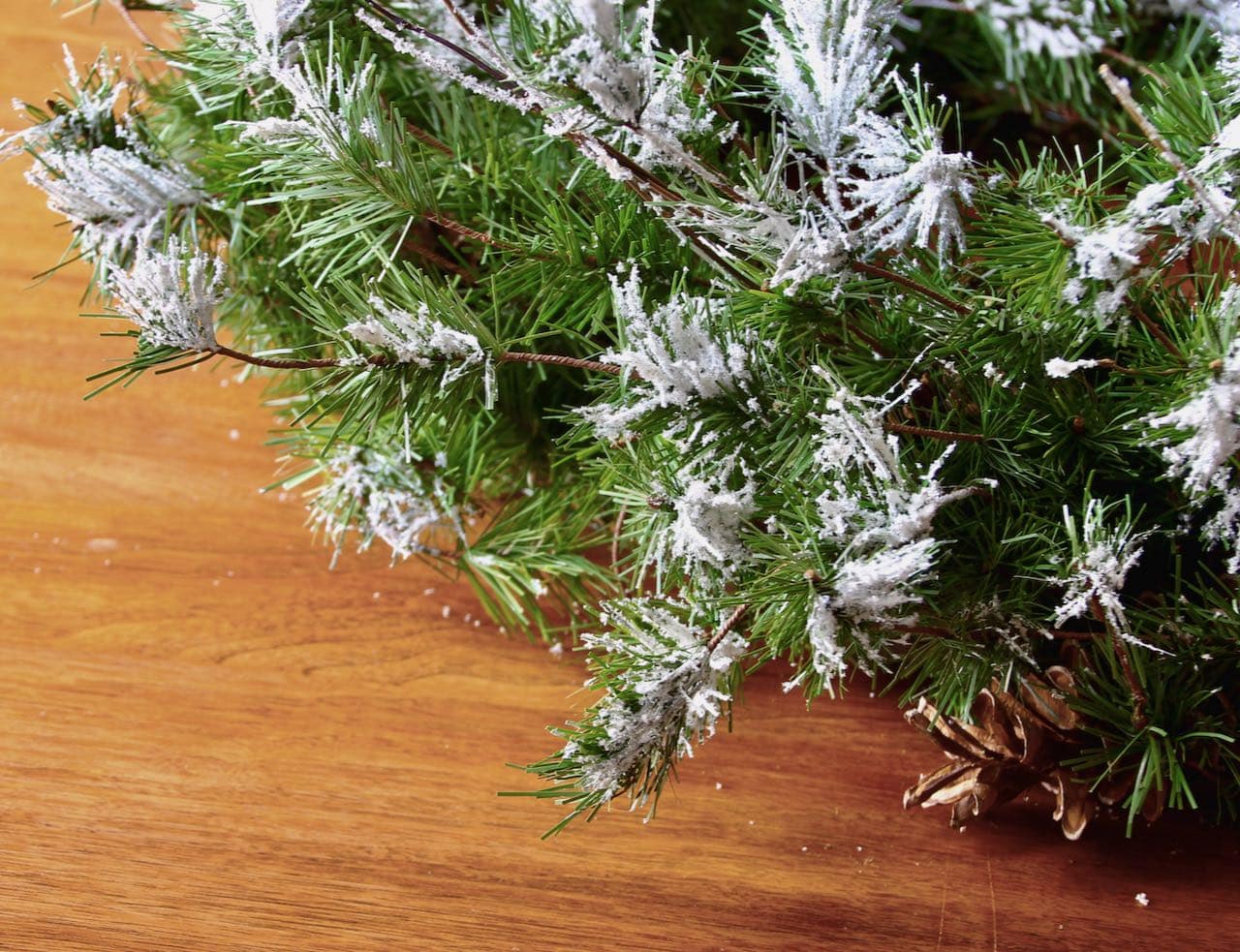 closeup of artificial fir wreath that has been flocked with artificial cial snow