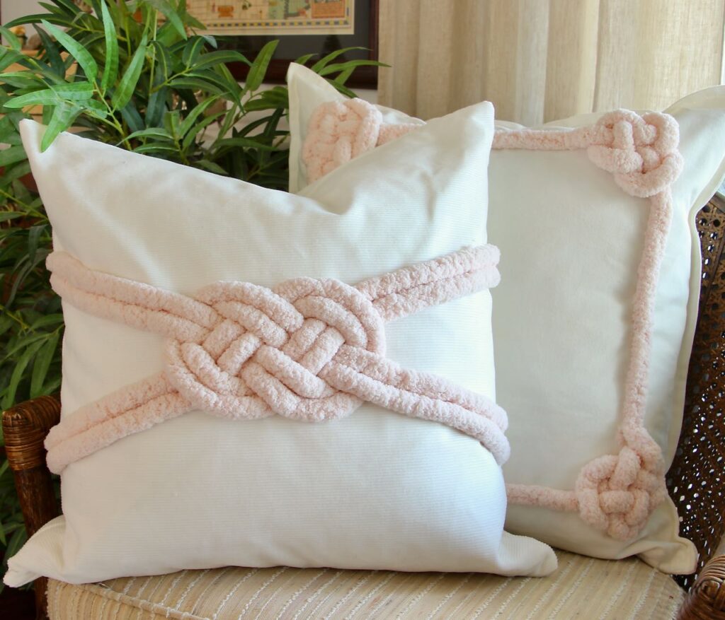 Two Valentines Day pillows with applied macrame inspired lovers knots on the pillow fronts
