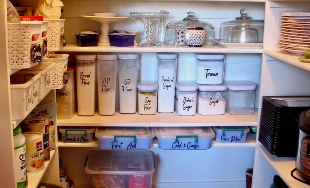 closeup of canisters with black lettering identifying the different flours and sugars contained in each.