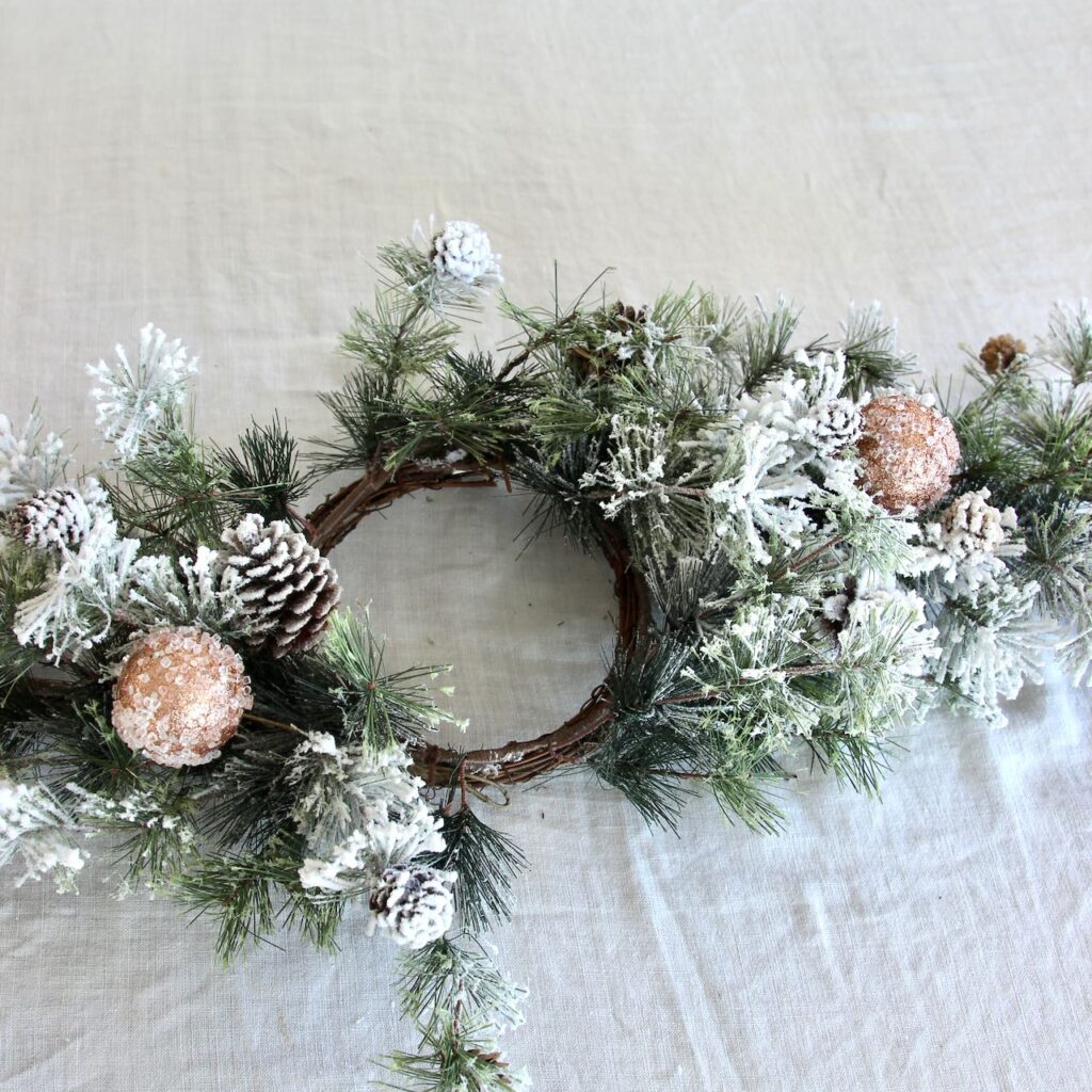 The candle ring centerpiece with two. of the rose gold frosted bulbs added and the branches bent to make two clearing around the ring