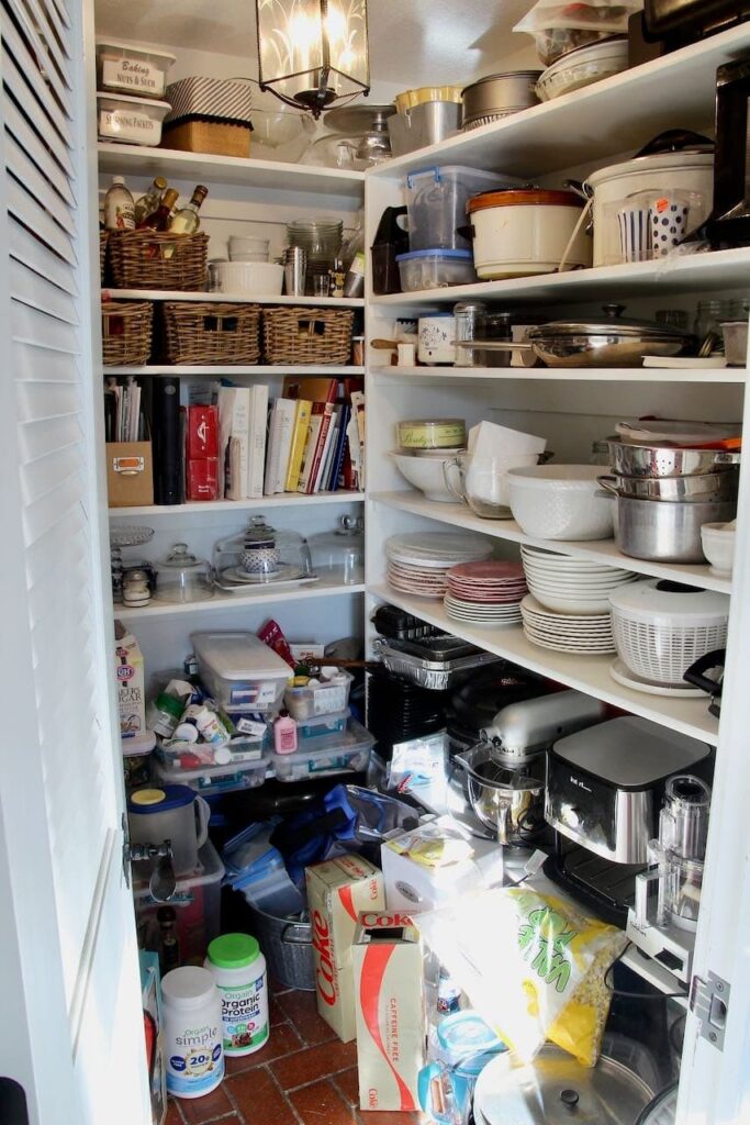 A before image of the West and North side of Walk in Pantry in a mess.