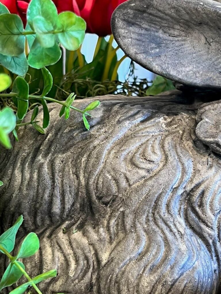 super closeup of the detailing of the black craft paint wash settling in the grooves of the statue giving it the vintage concrete look