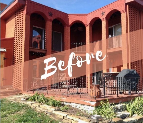 Before picture of the back of a two story house with large patio that is a bit of a crumbling mess