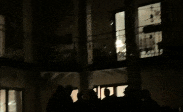 Gif of crowd gathered in the dark and then the lights come on and everyone celebrates
