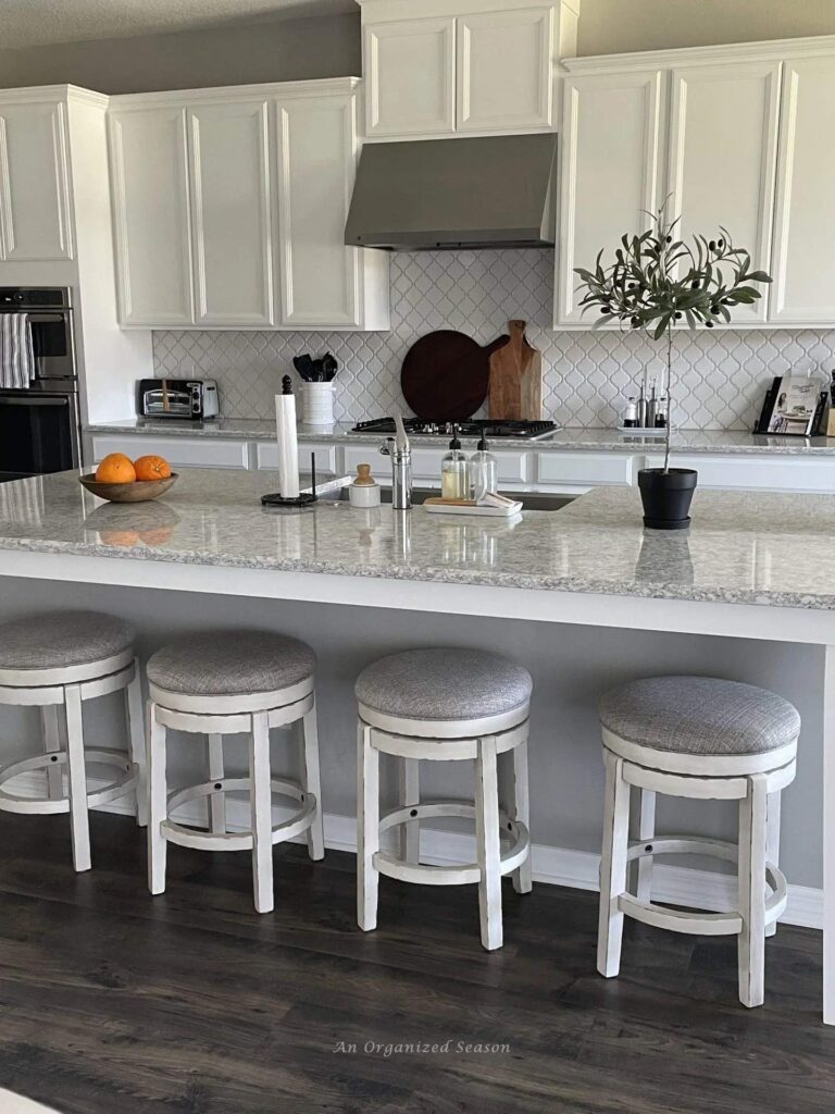 a bright, light kitchen with new arabesque shaped white backsplash tile.