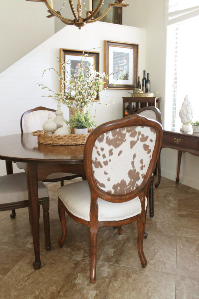 Four newly upholstered chairs are shown gathered around a round table