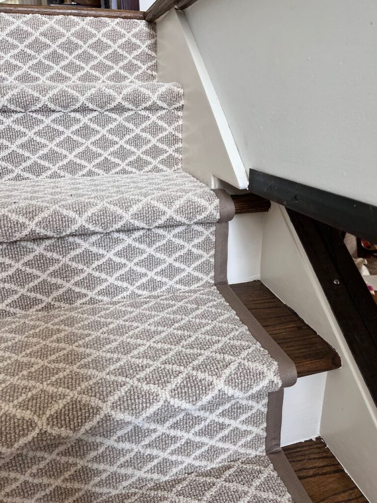 Closeup of the stair runner cut around wall