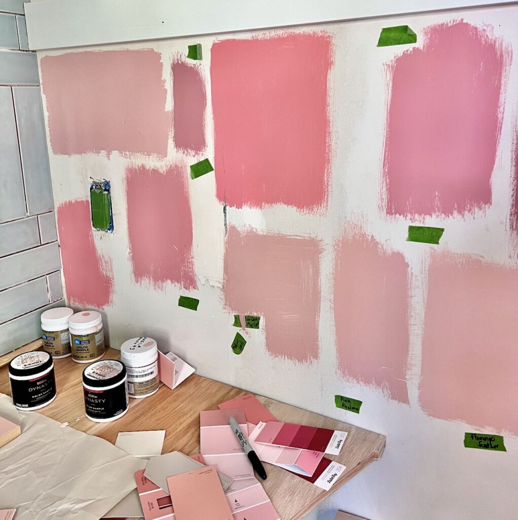 wall of handpainted samples of many coral paint colors