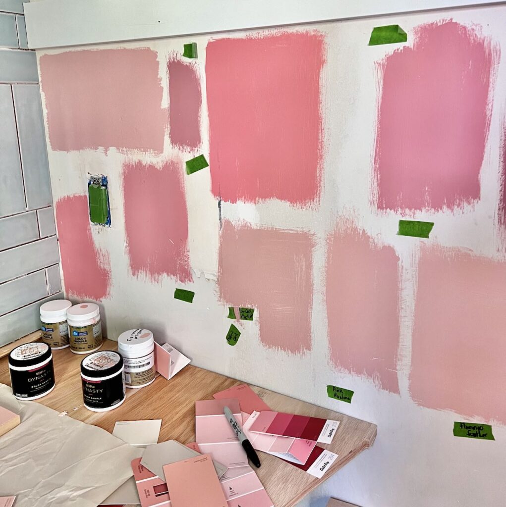 wall of handpainted samples of many coral paint colors