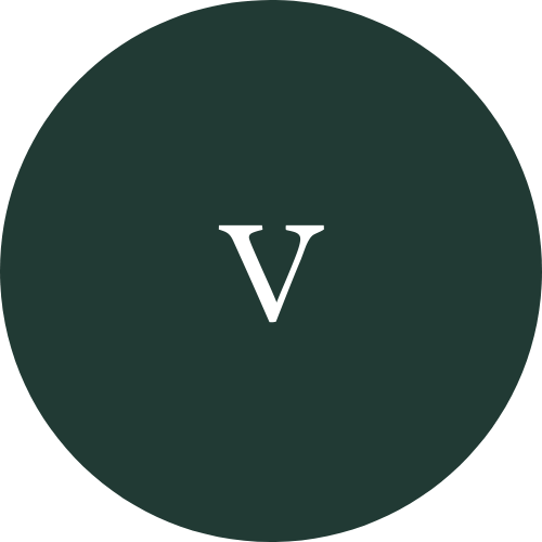 A white capital letter "V" centered on a dark green circular background.
