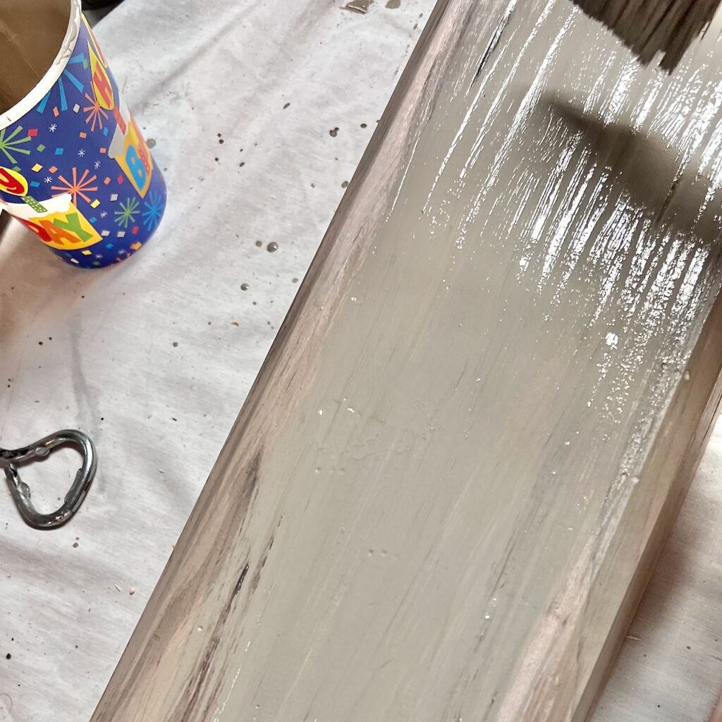 closup of bristles of a paintbrush applying the final glaze