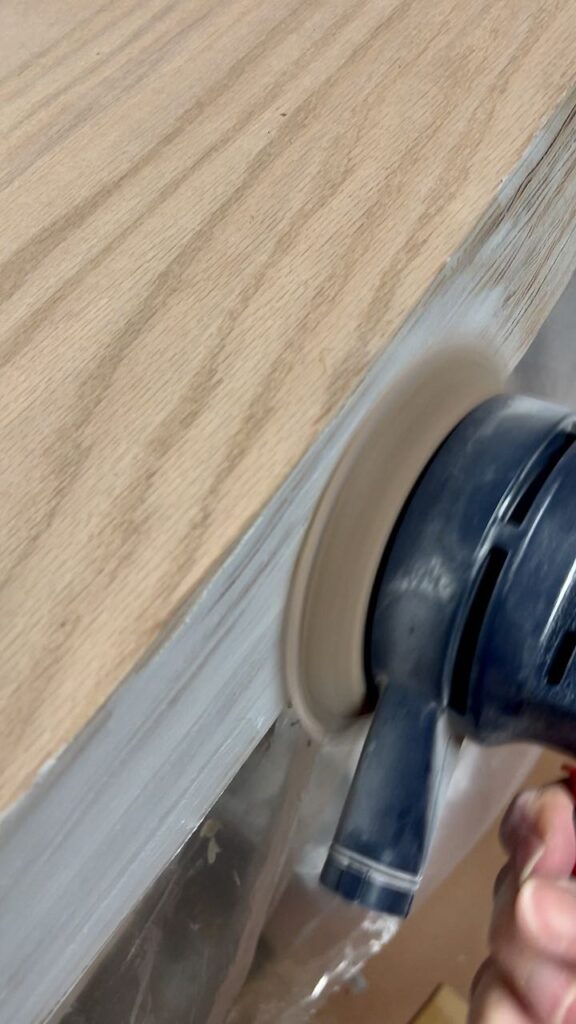 closeup of an orbital sander on the front apron of the countertop