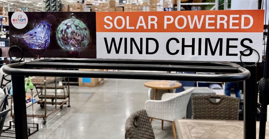 image of a sign at Lowes that says "Solar Powered" over "Wind Chimes' atop an empty rack