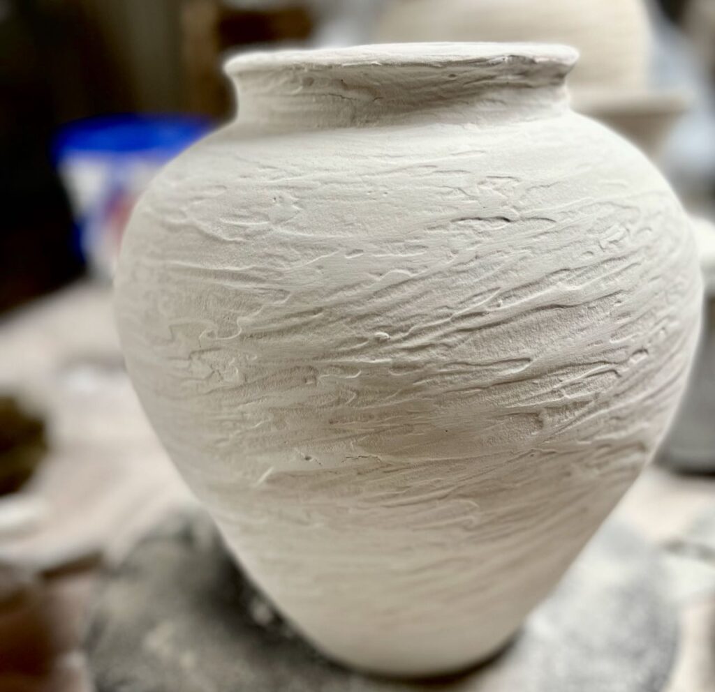 closeup of a rustic vase as the joint compound layer is drying
