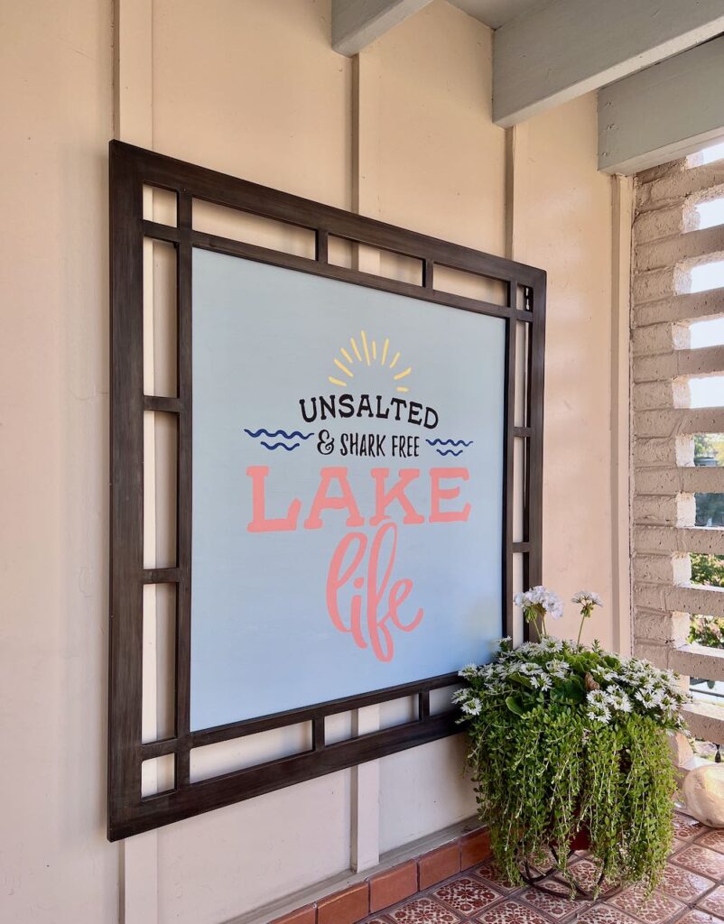 Side view of our fun patio sign that reads "Unsalted & Shark Free Lake Life"
