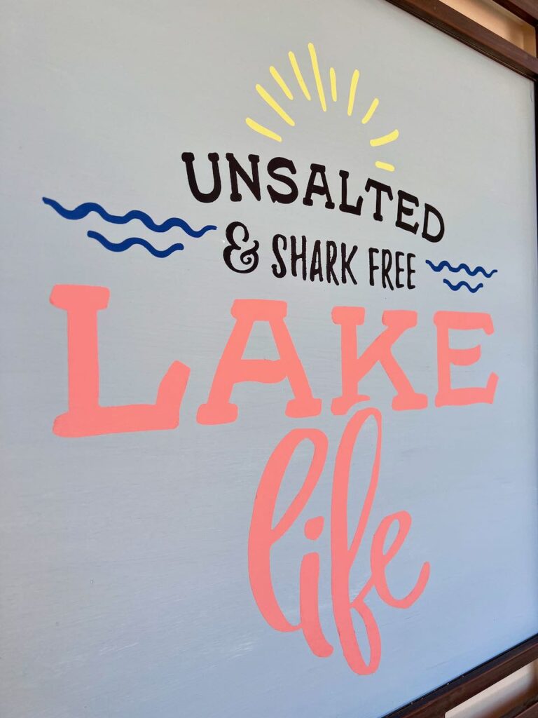 close up of the painted sign. focusing on the words "Lake Life"