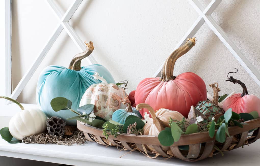 A basket full of craft decor pumpkins made of velvet