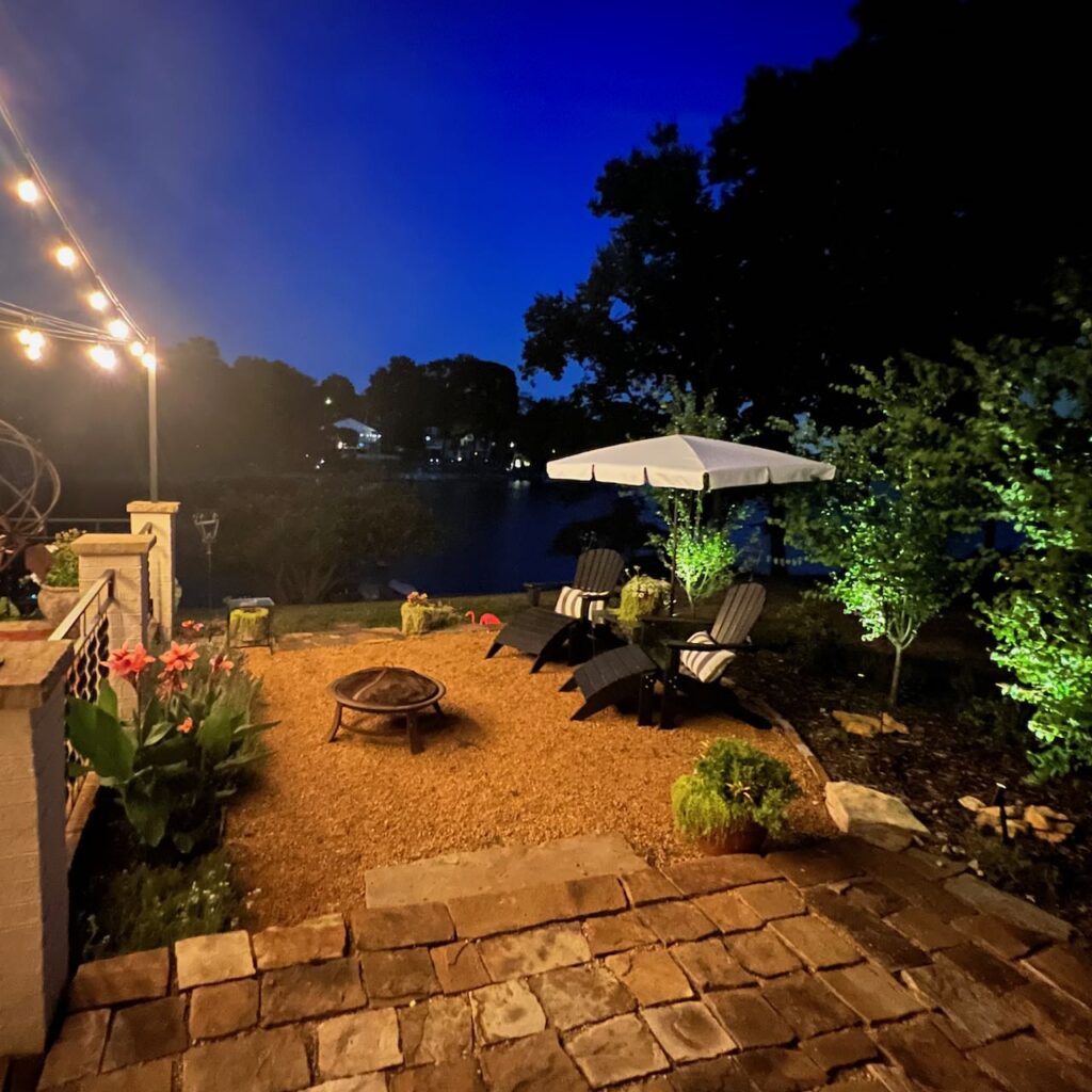 modern landscape lighting including uplit trees and strings lights