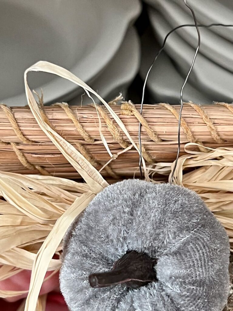 Closeup of the wire from the basket label threading through the weave of the basket