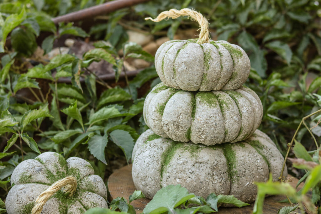 a stack of three decor craft pumpkins made of concrete