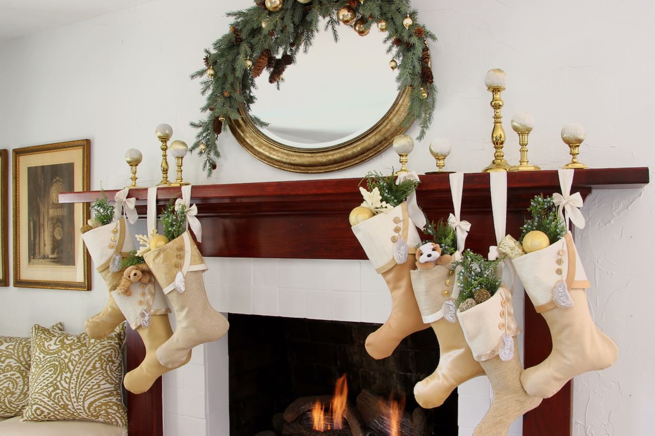 7 Christmas stockings with agate name tags flank each side of the fireplace