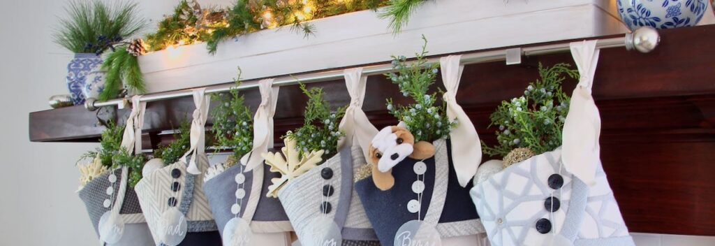 stockings hanging on a silver rod held by two robe hooks on a wood mantel cover