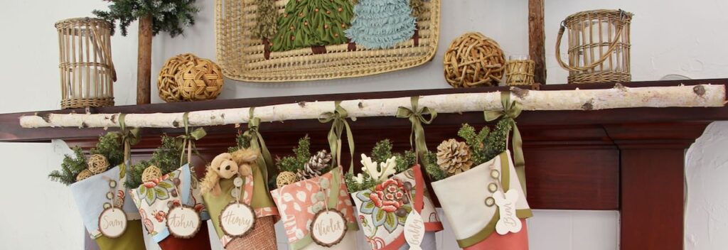 wide closeup of stockings hanging on a birch branch attached to a wood mantel cover with curtain rod hangers