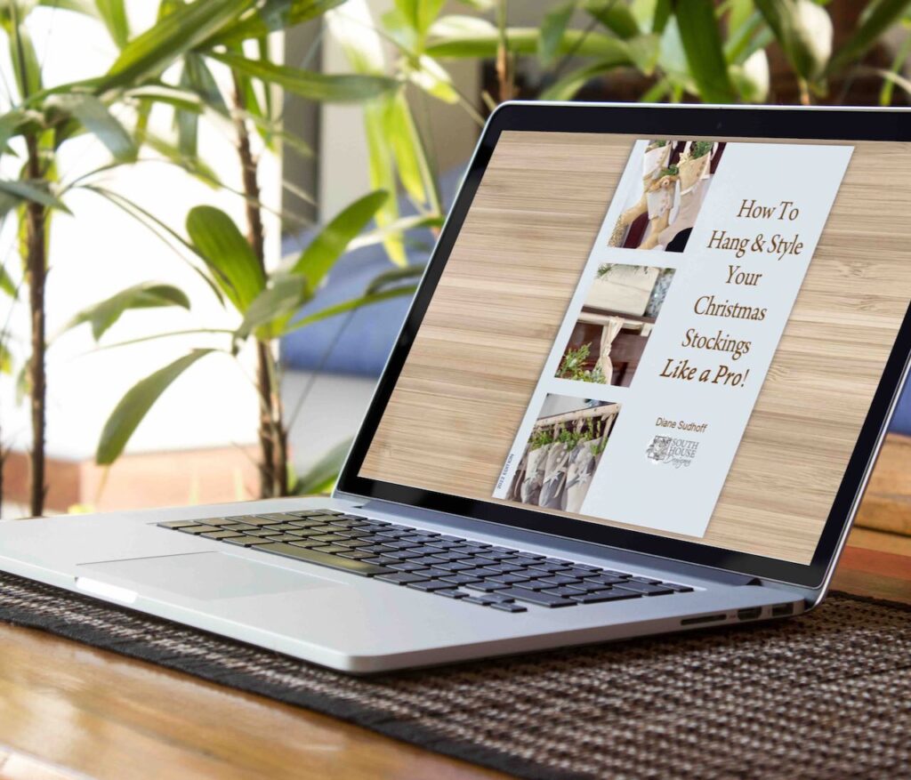 Closeup of laptop on a desk with the screen showing the cover of the ebook