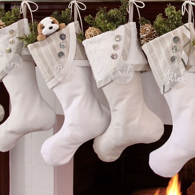 closeup of 4 casual Chhristmas stockings in whites and taupes for neutral decor