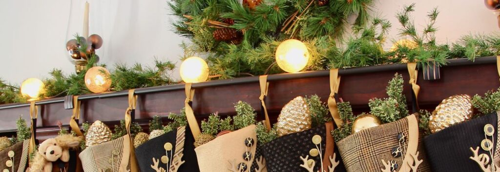 Wide Closeup of stockings hanging from a rod held by two door knobs attached to a mantel cover