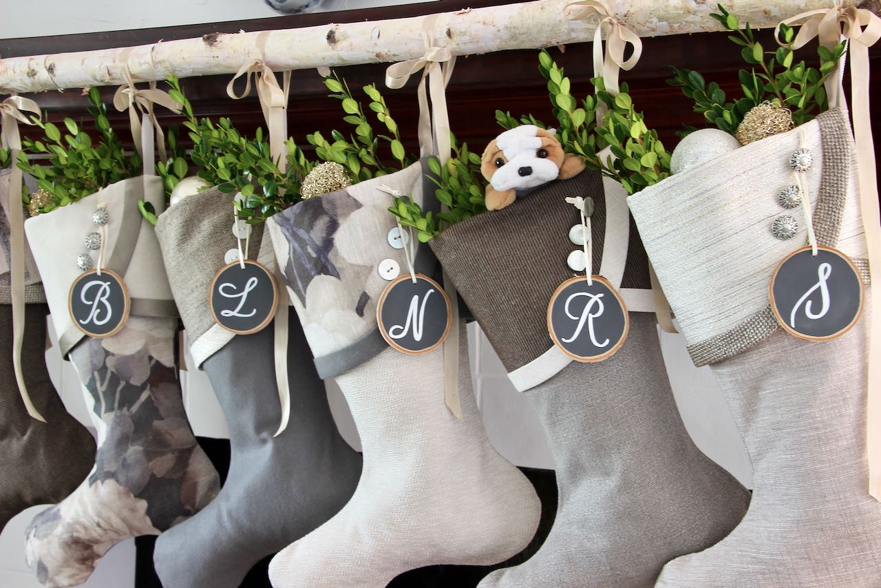 closeup of modern Christmas stockings hanging from birch branch