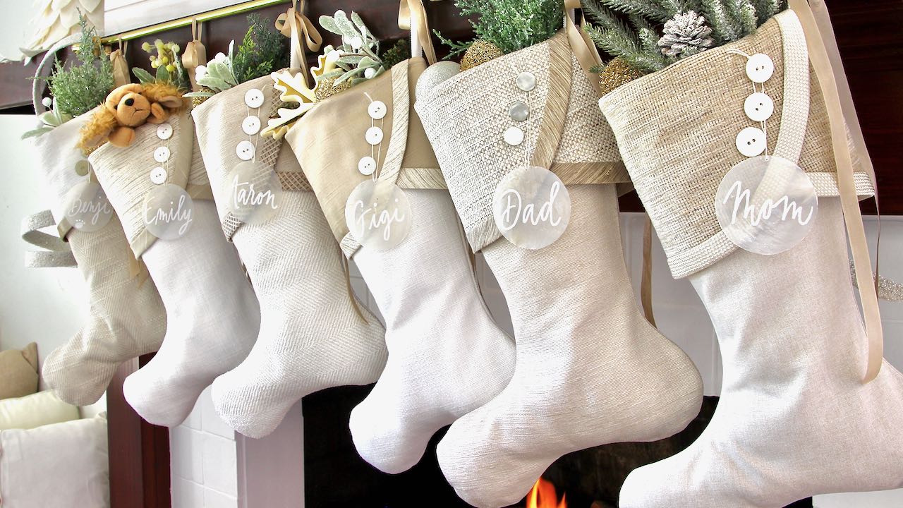 6 coordinating white christmas stockings with capiz shell name tags