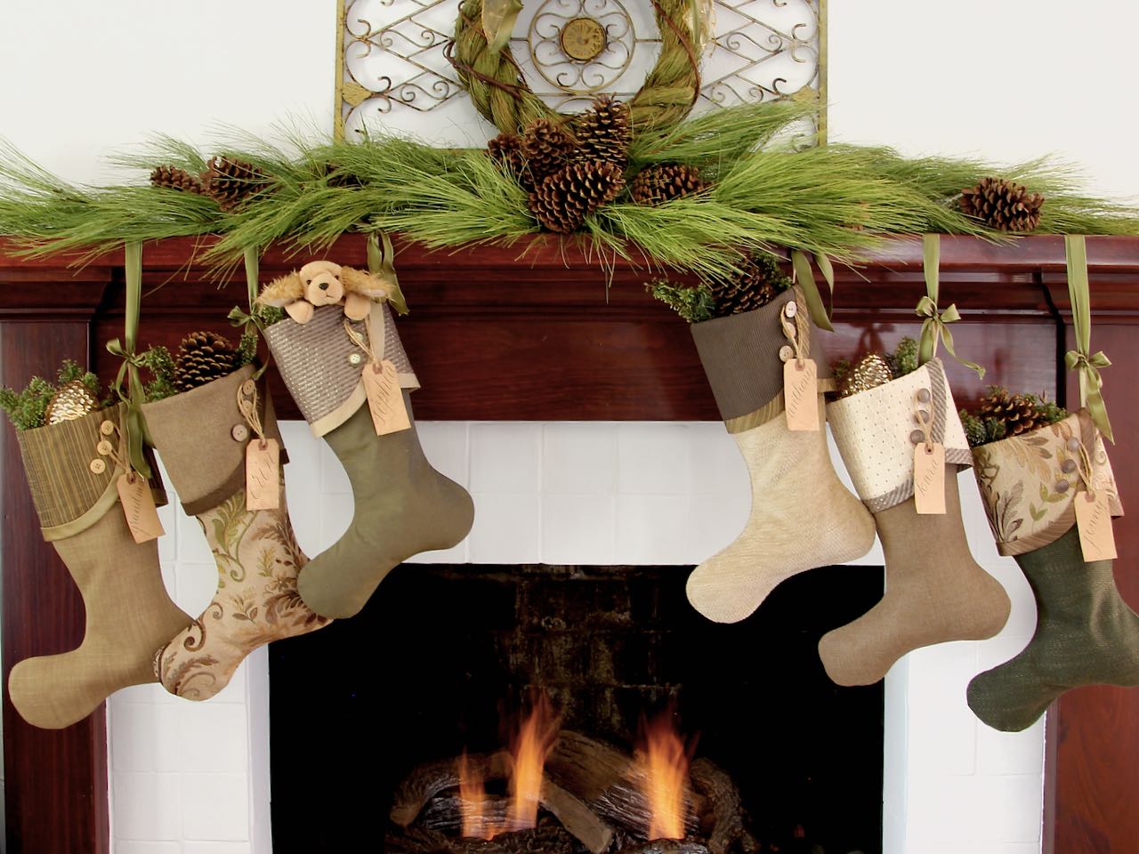 Stockings with custom name tags flanking a fireplace