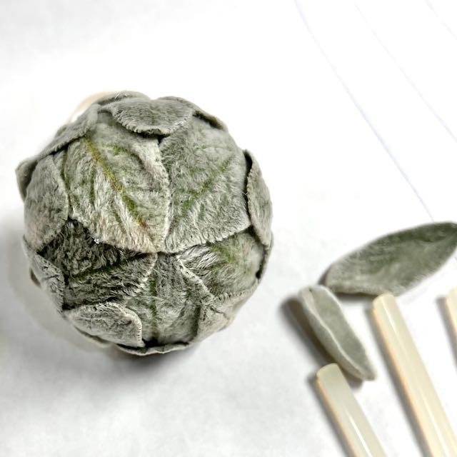 Closeup of the bottom of a fully covered lambs ear ornament showing the leaves all coming together