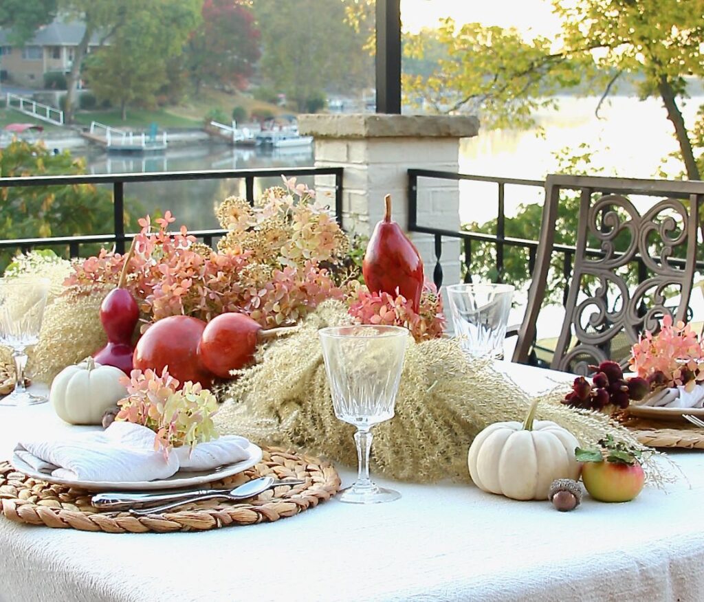 image of outdoor table with a Fall Foraged Centerpiece and four places set