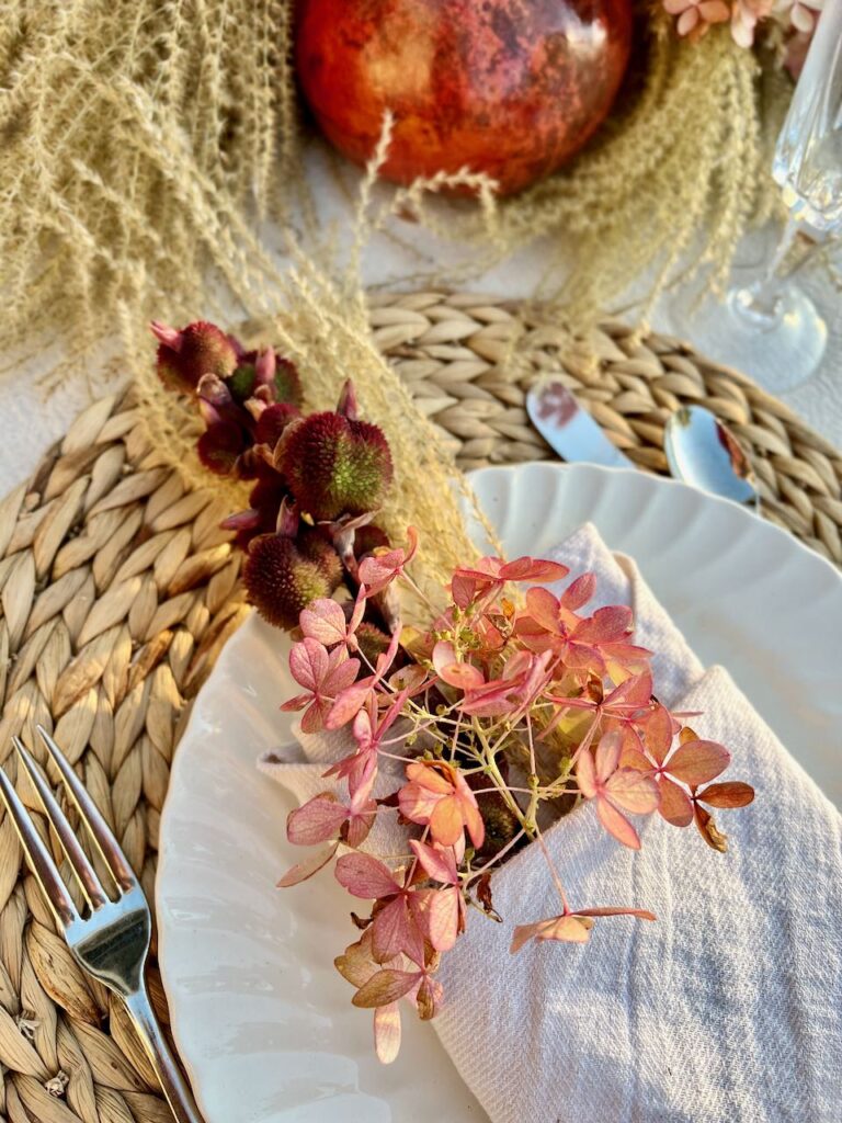 closeu of foraged plants in a linen napkin pouch on a white dinner plate