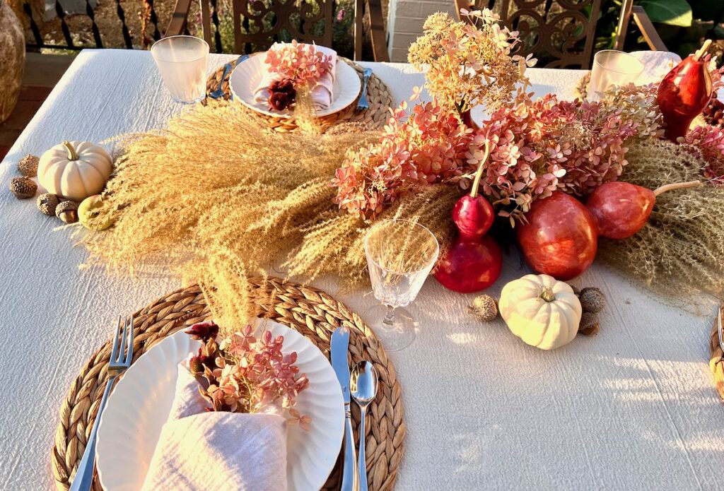 MORNING sun shining brightly on half the centerpiece and two place settings