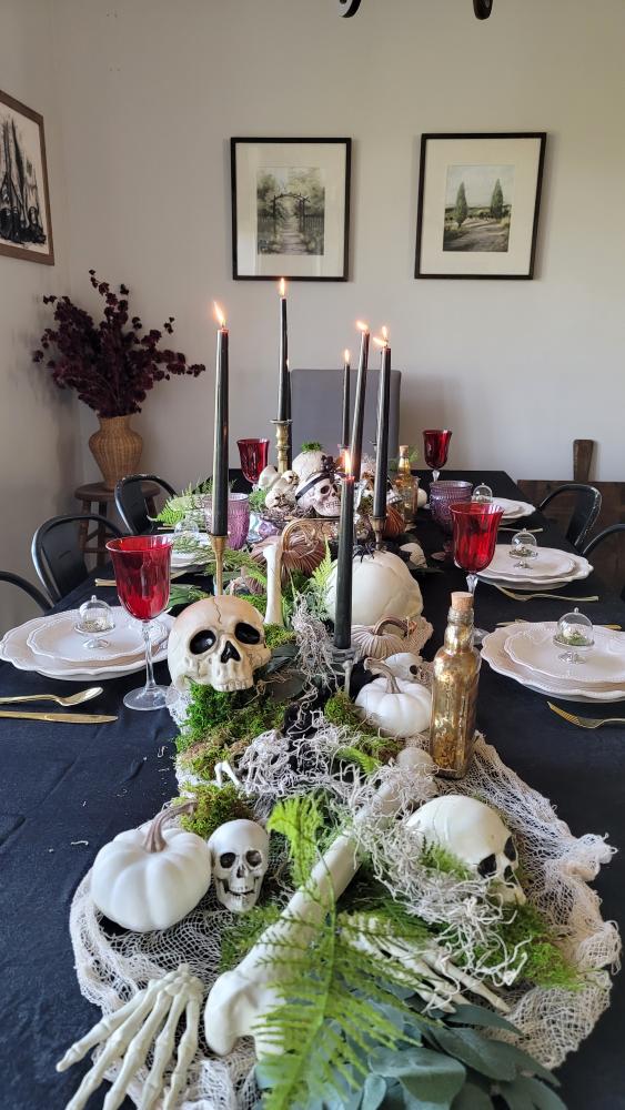 Dining table set for Halloween with skeleton bones and creepy accents