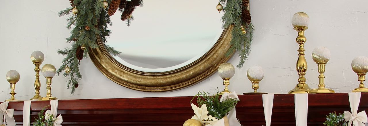 wide closeup of revived Christmas ornaments on brass candlesticks on a mantel