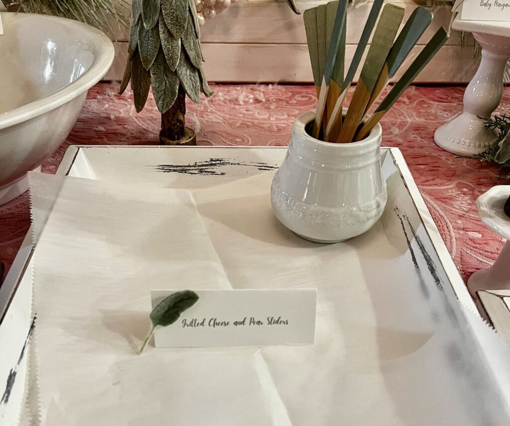 closeup of a platter with parchment paper and a container of bamboo forks on it