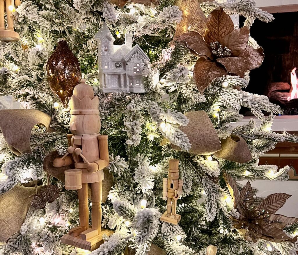 closeup of the decorations on a flocked Christmas tree