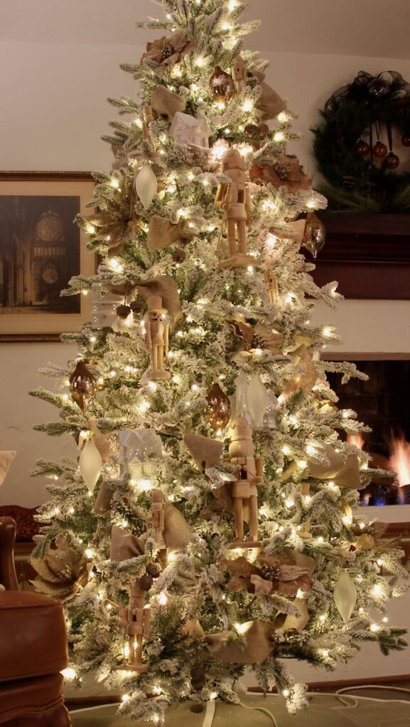 a full length view of the fully decorated Christmas tree at night