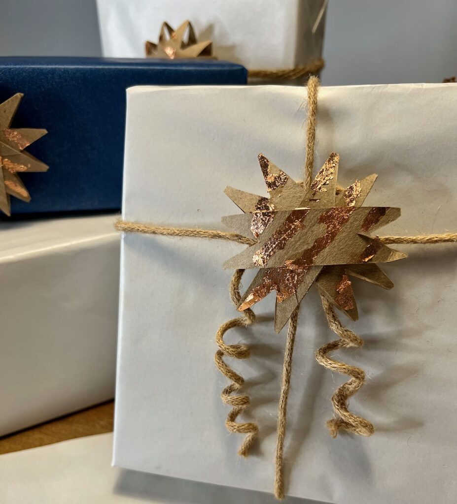 closeup of a star tied onto a white package with twine