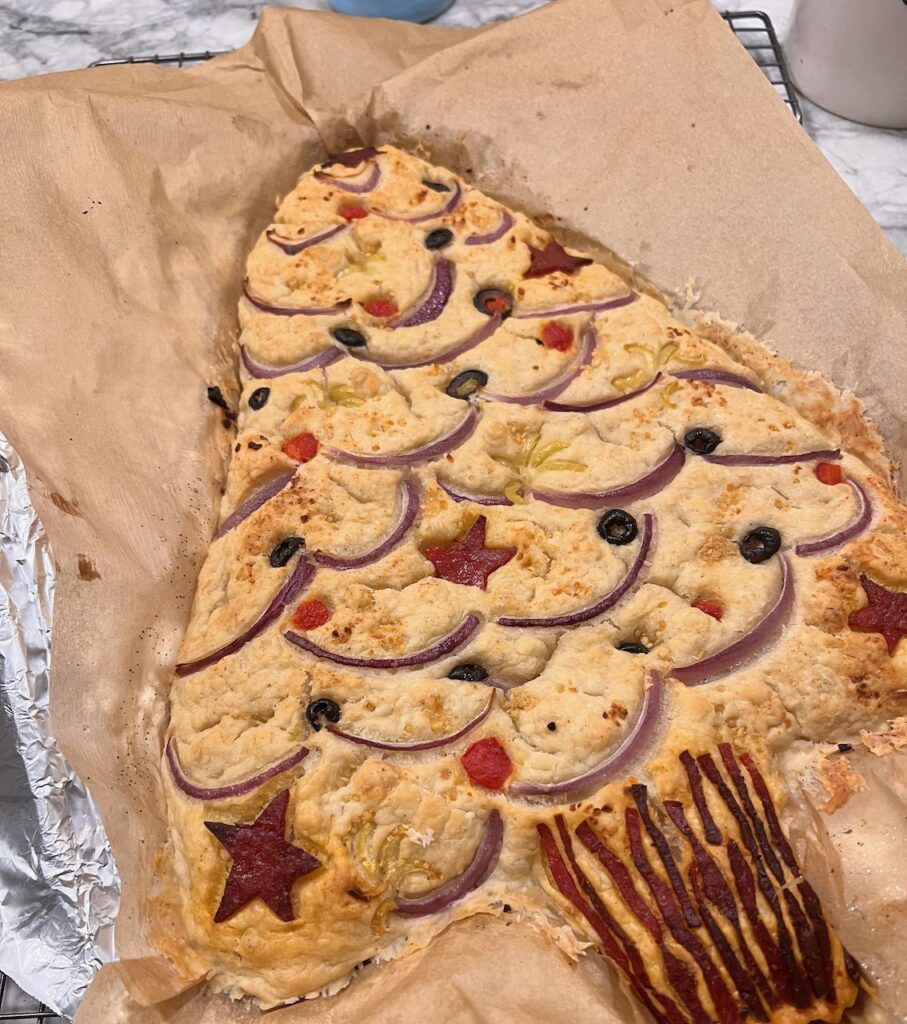 Focaccia Christmas tree out of the oven and cooling in the parchment lined pan