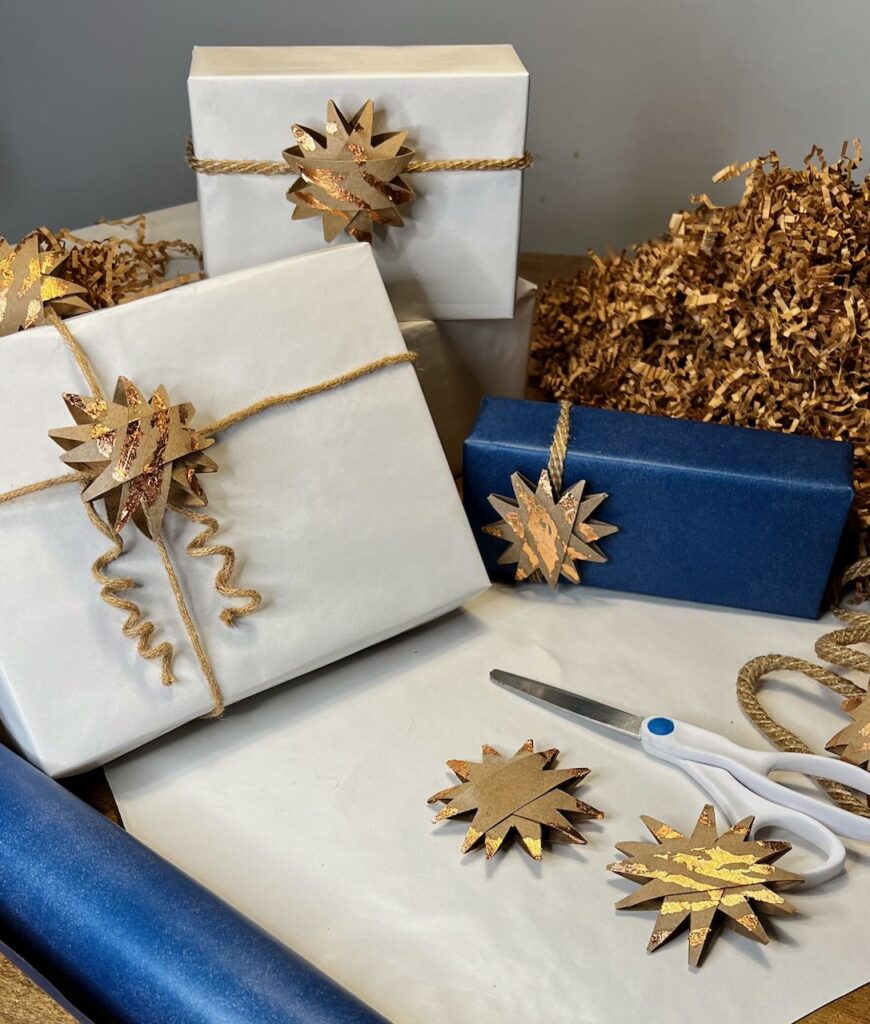 wrapped gift boxes with cording and stars for embellishment