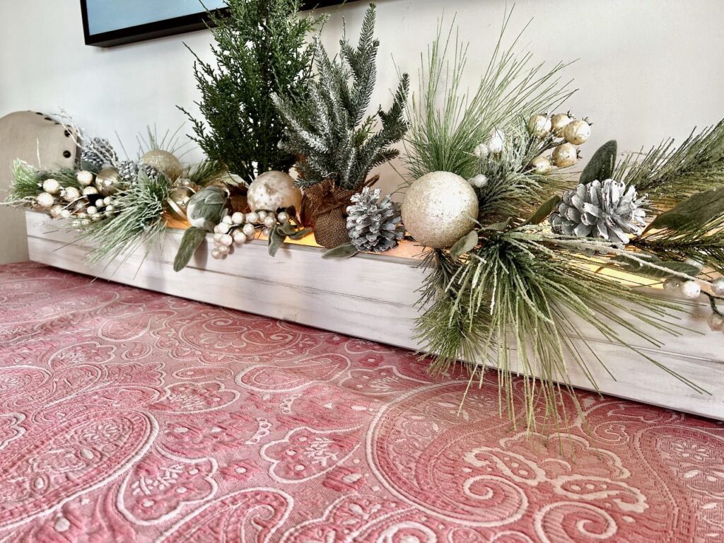 Long wide view of the backdrop box with Christmas greenery