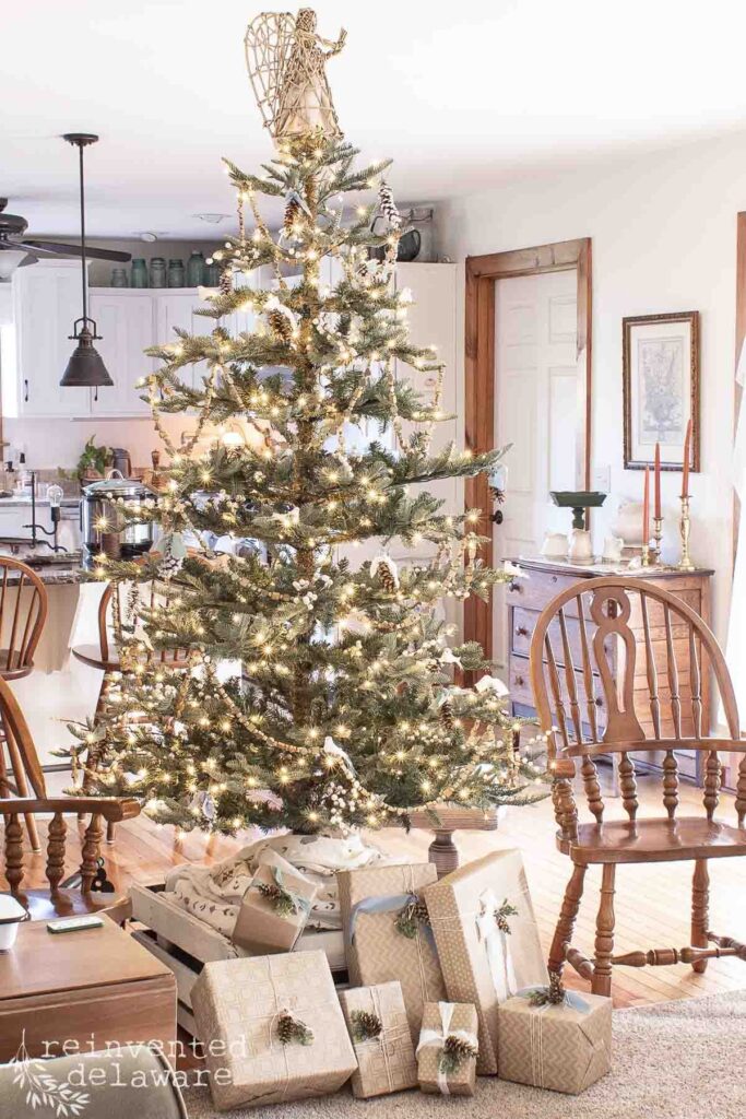 Farmhouse Christmas tree across the room with coordinating packages under