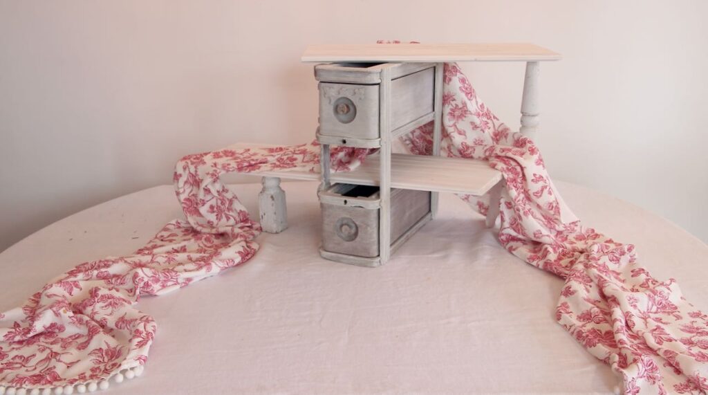 vintage sewing drawers as a display with two shelves and a table runner