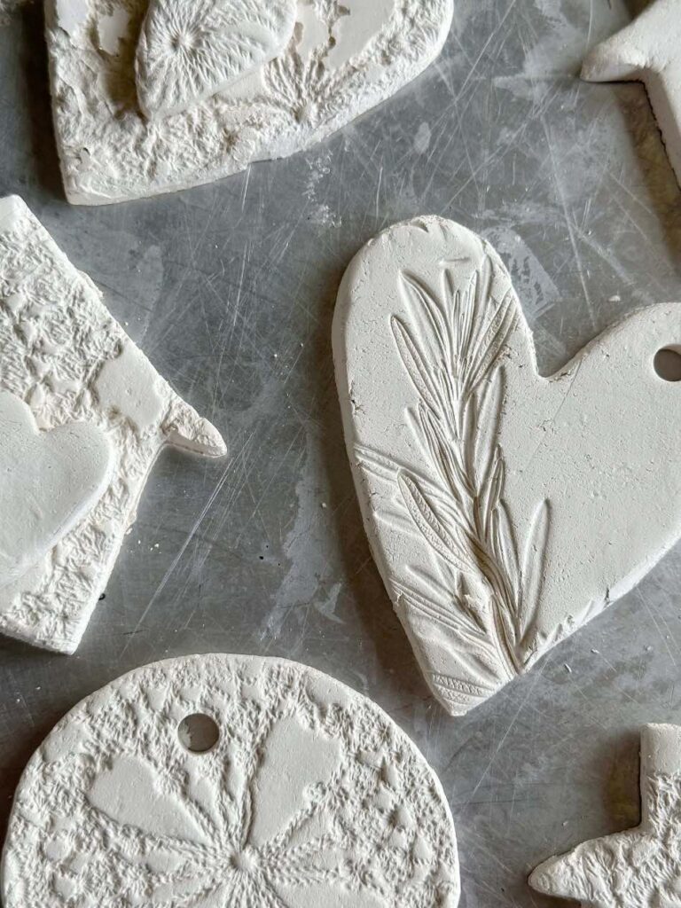 closeup of clay ornaments with stamped flower impressions